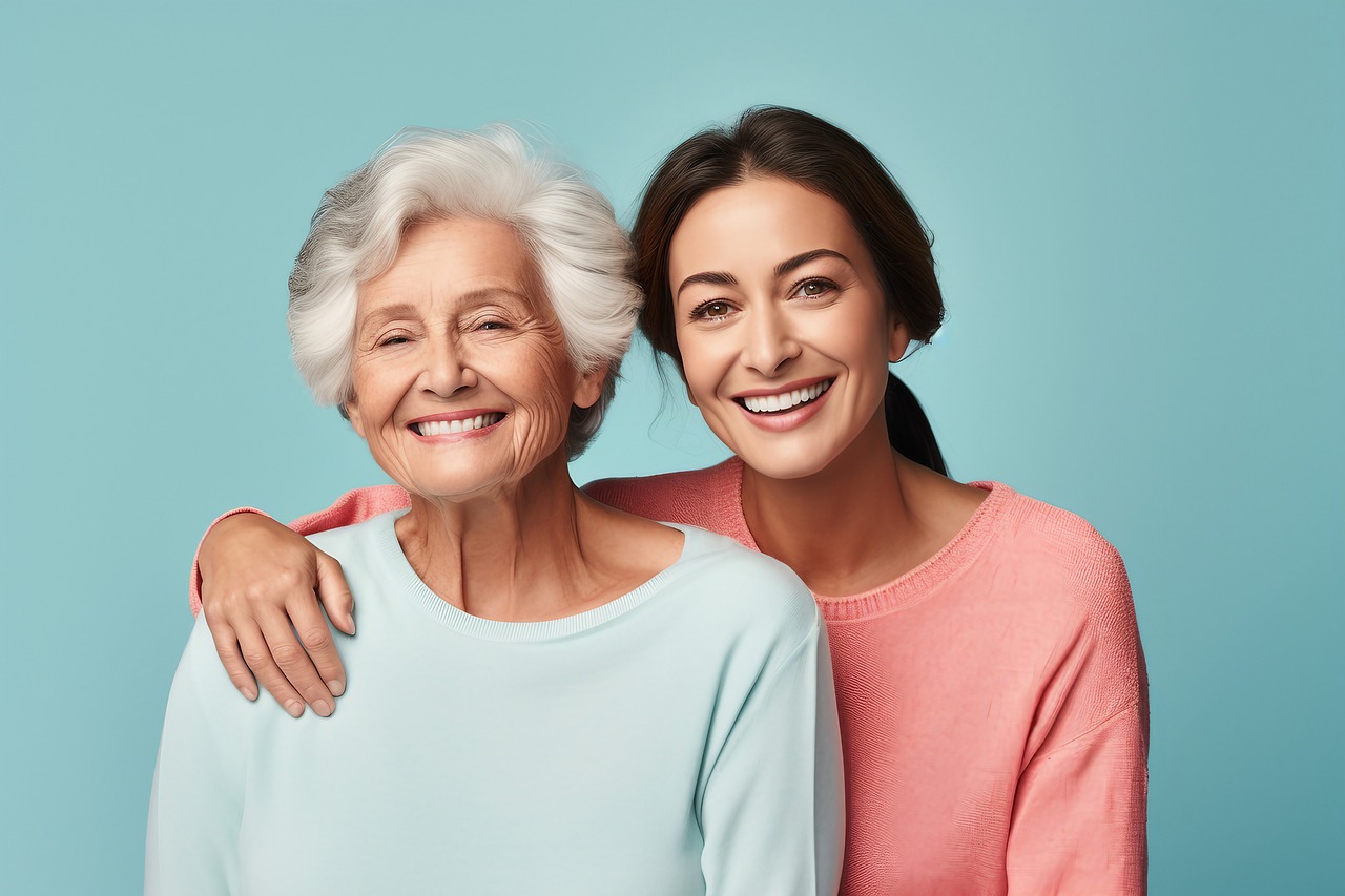 Older woman and younger woman sitting together and smiling