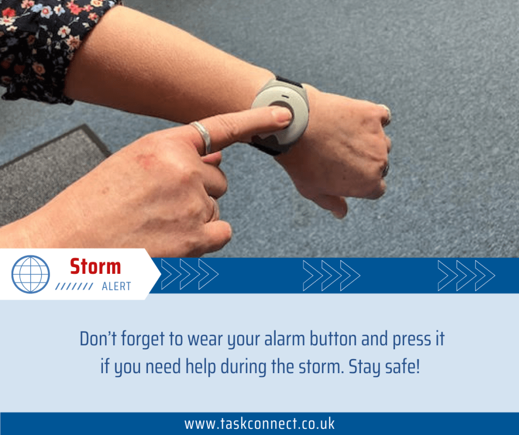 Finger pressing a wrist-worn alarm button in a TASK Connect storm advice graphic
